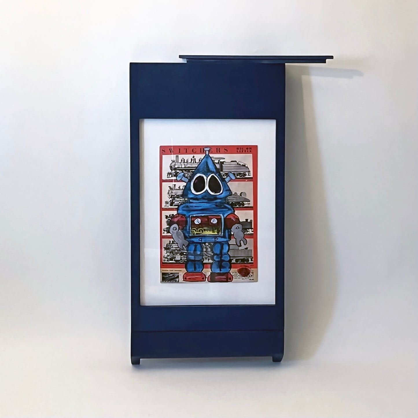 PicChair in blue; view of chair folded up as a frame with art on the wall.