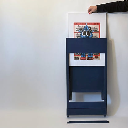 PicChair in blue; view of chair folded up as a frame with art being changed.