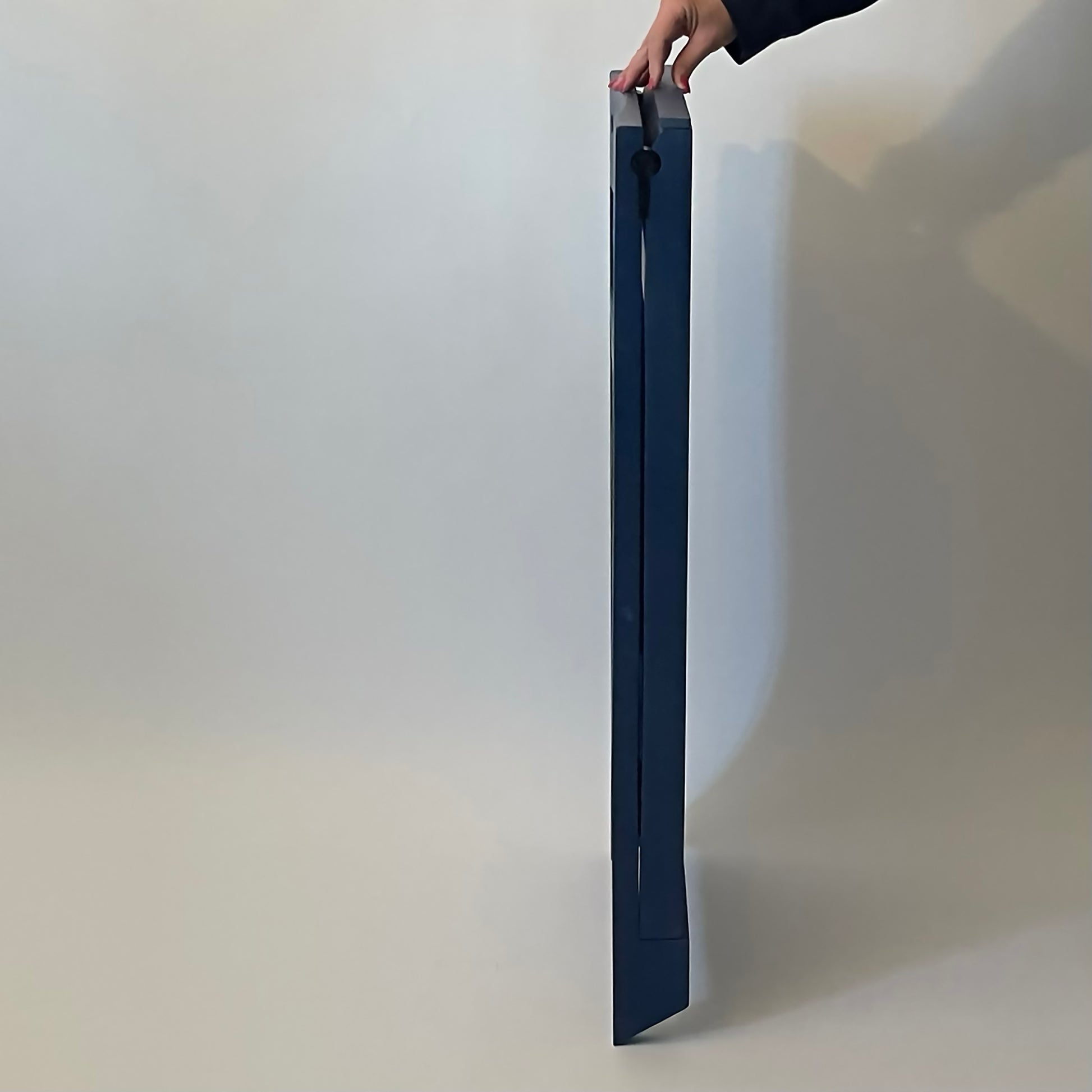 PicChair in blue; side view of chair folded up as a frame.