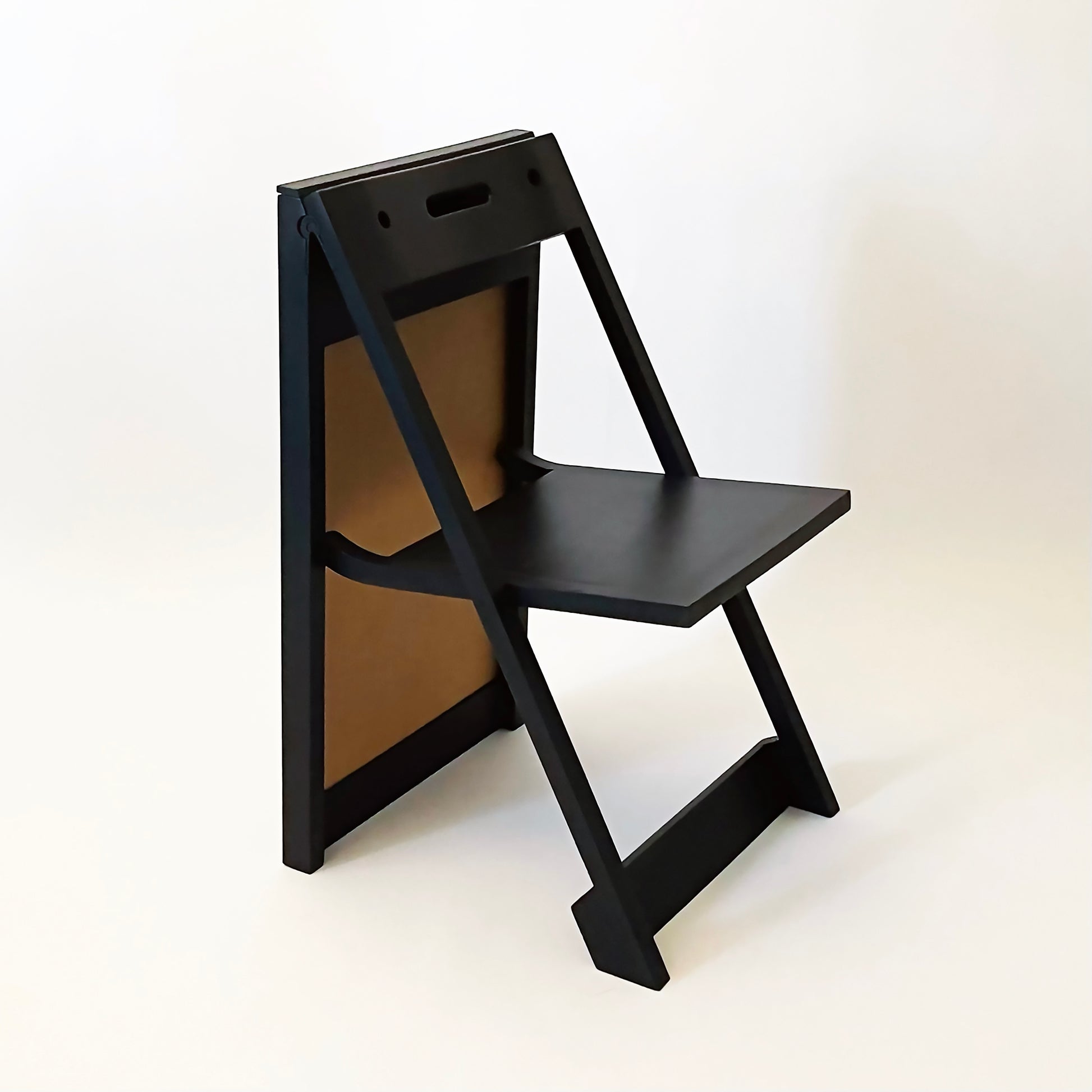 The PicChair in Black ,opened up as a chair. Two holes and handle are showing.