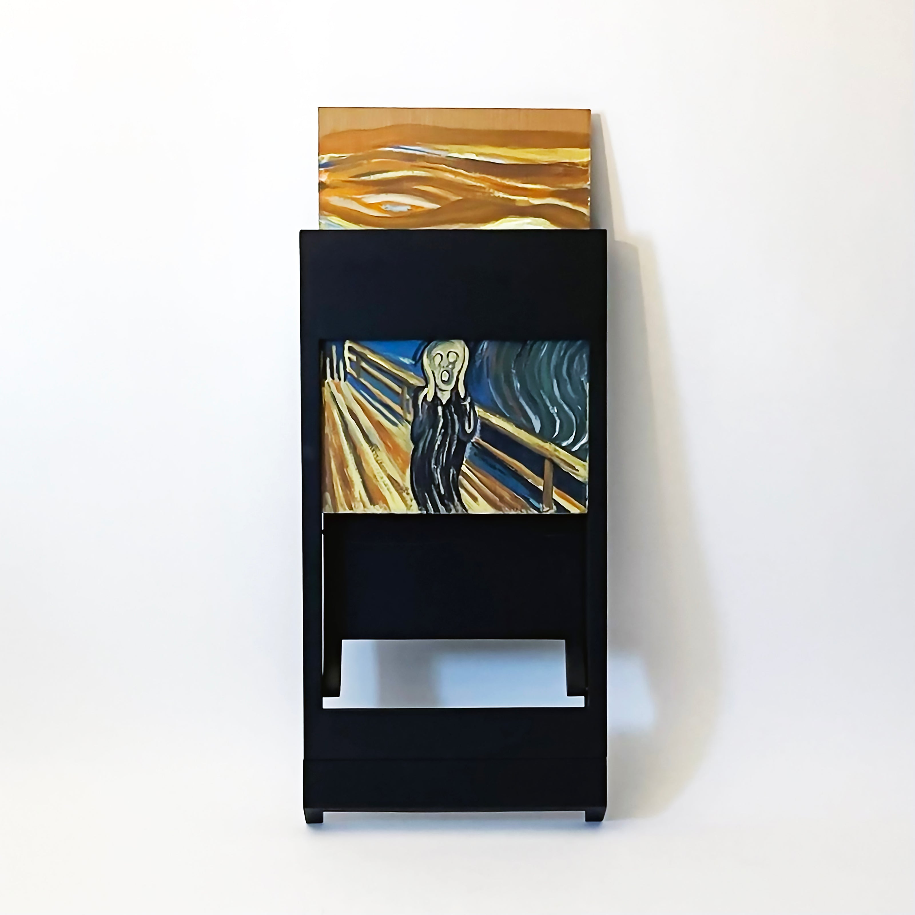 PicChair in black; view of chair folded up as a frame with art being changed.
