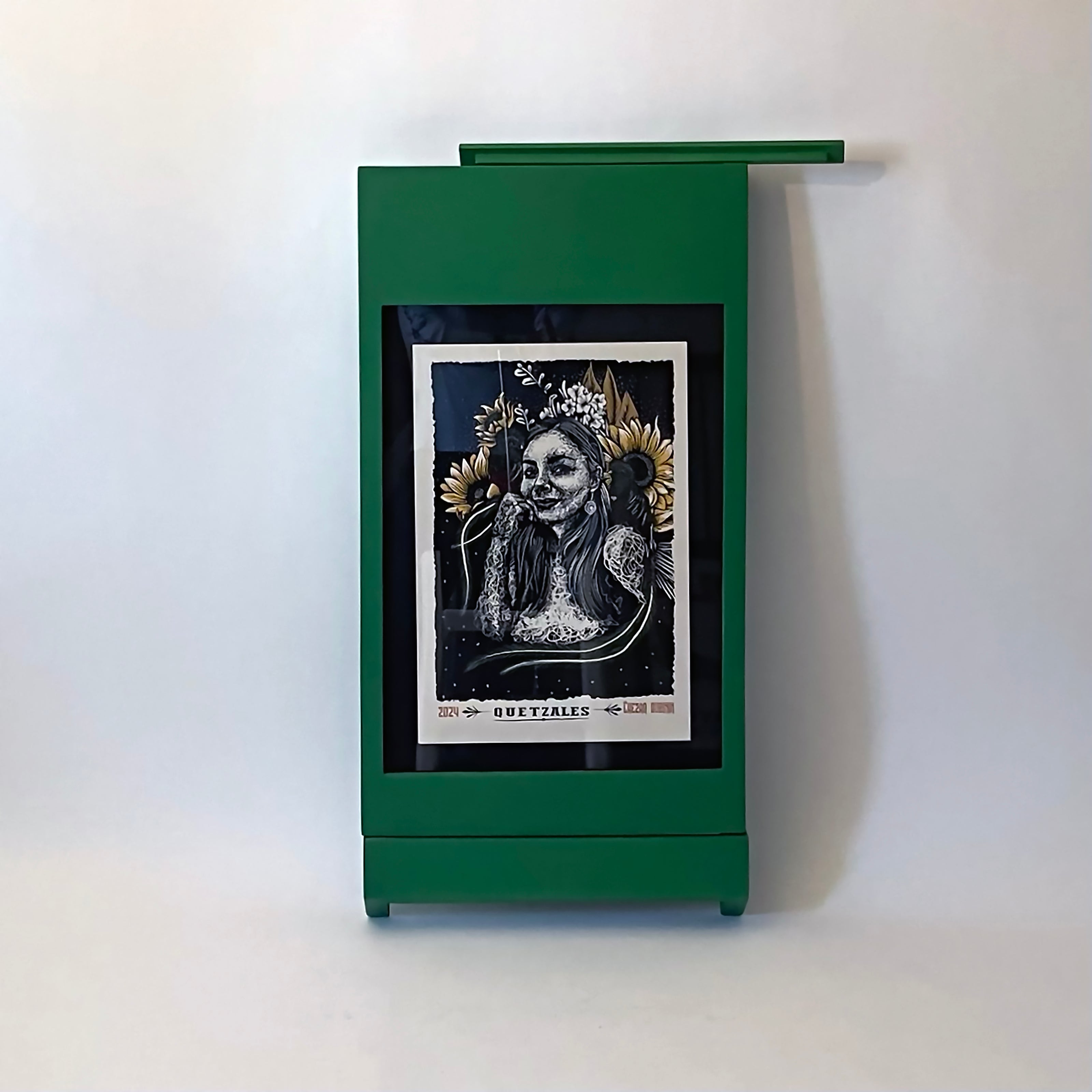 PicChair in green; view of chair folded up as a frame with art on the wall.