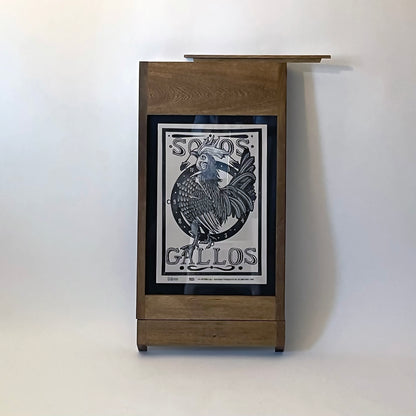PicChair in dark oak; view of chair folded up as a frame with art on the wall.
