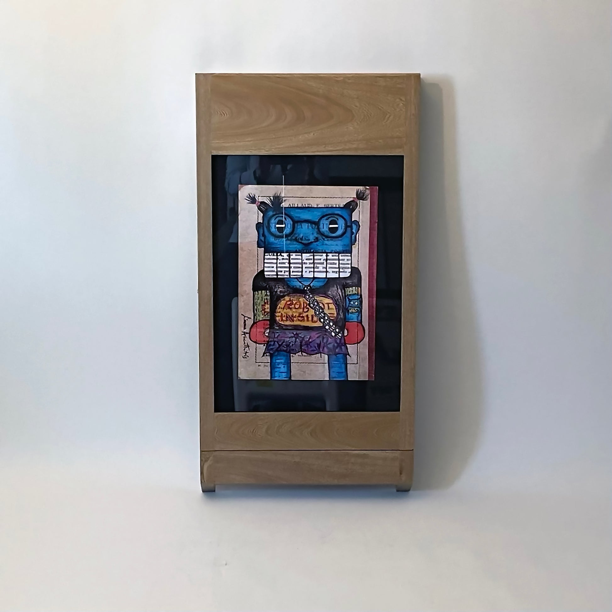 PicChair in natural oak; view of chair folded up as a frame with art on the wall.