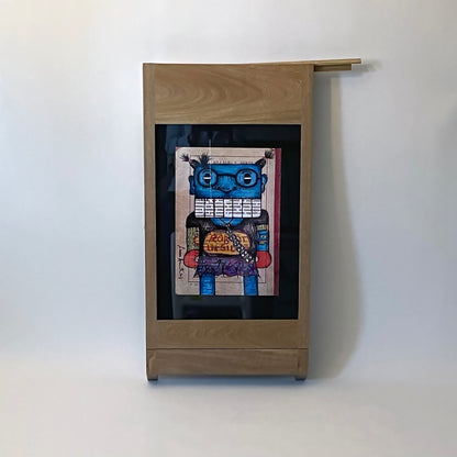 PicChair in natural oak; view of chair folded up as a frame with art on the wall. shows picture slot cover .