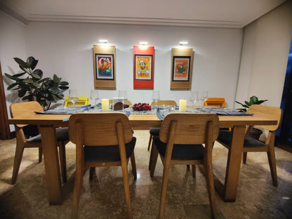 Dining room with 3 extra. PicChairs on walls  and 2 PicChairs on open