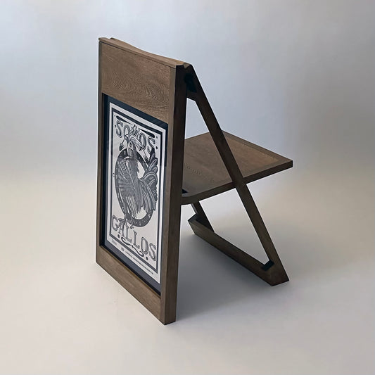 The PicChair in dark oak; Poster with a graphic illustration of a bird.